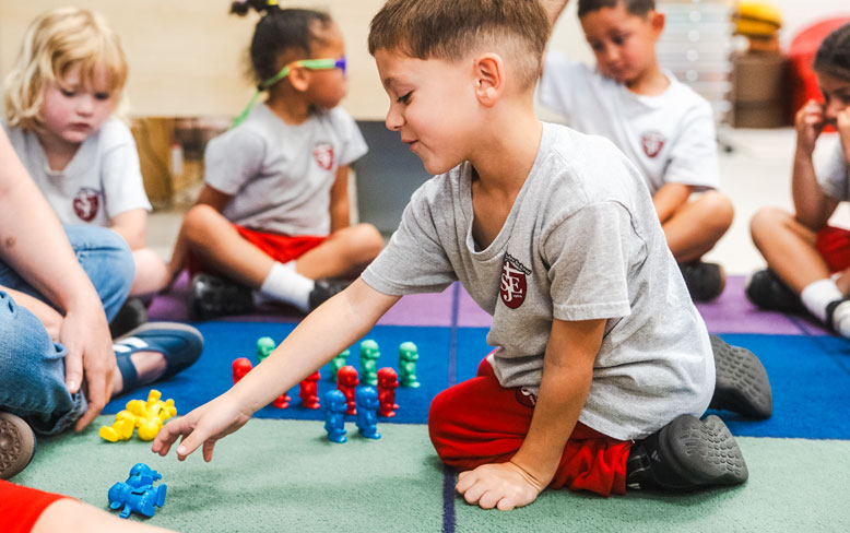 Young boy playing in classroom