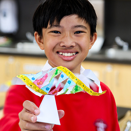 innovate BOY STANDING WITH SCHOOL EXPERIMENT