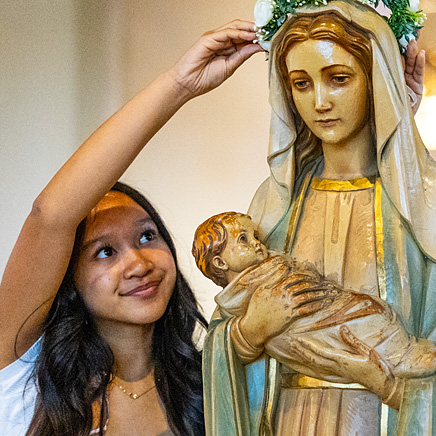 serve Girl in church with statue of Mary