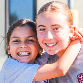 Two girls hugging
