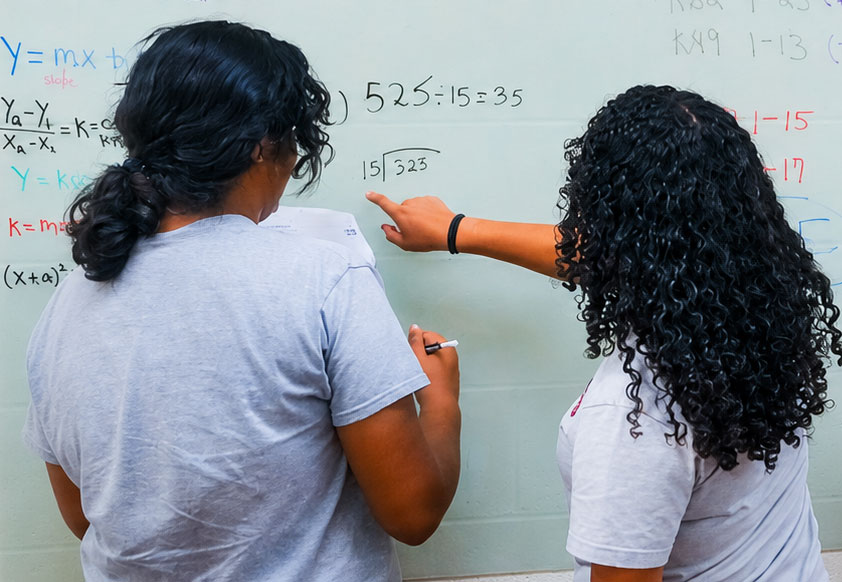 SJE_NJHS-students-working Two students working on a math problem